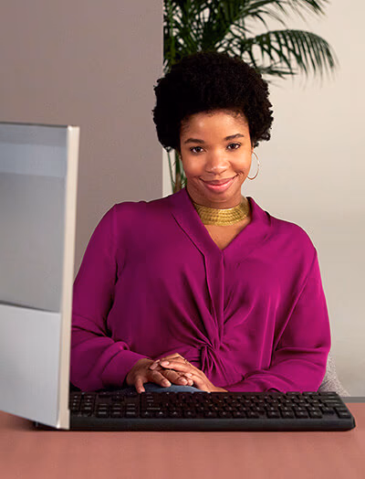 Smiling web developer sitting in her office.
