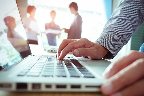 Someone typing on a laptop keyboard