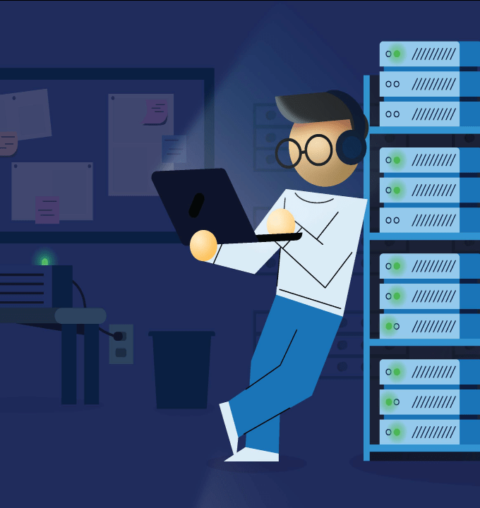 Sys admin standing with laptop in data center