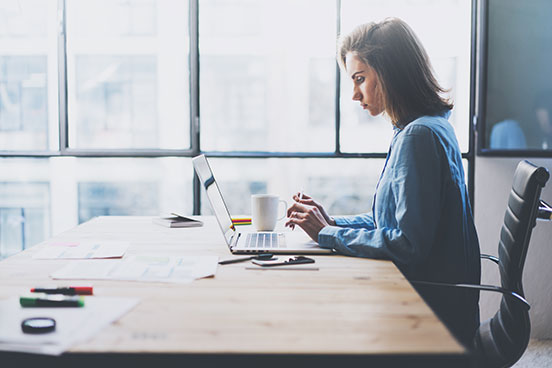 Woman at table with laptop